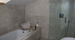 Overview of fully tiled stone shower enclosure and bath units.