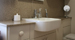 Inset basin is set off by the cream granite wall and countertop.